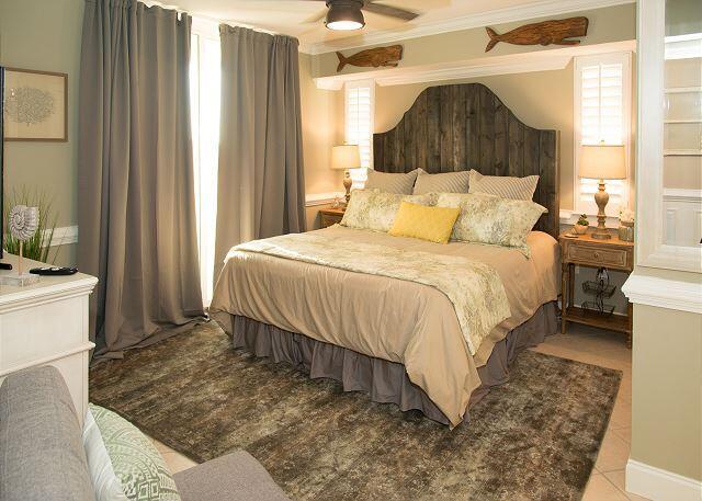 tiled bedroom with ornamental molding and ceiling fan