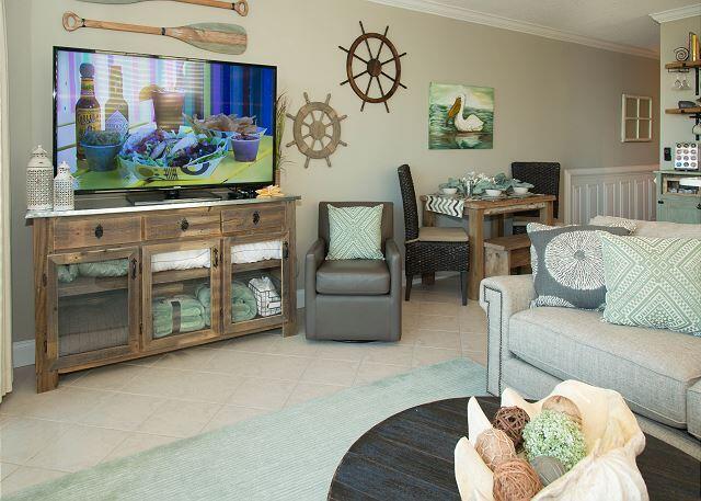 living room with crown molding and light tile flooring