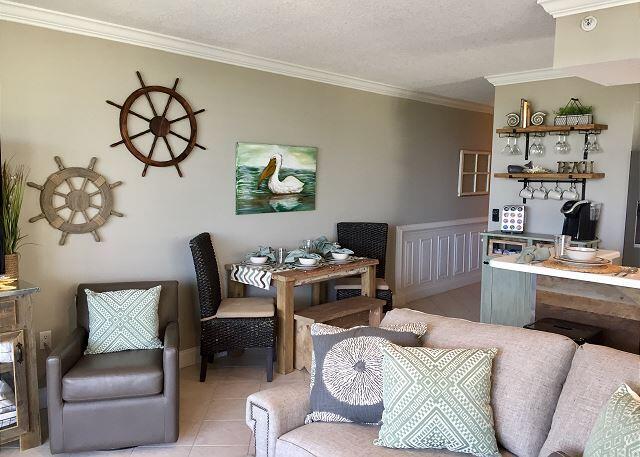 living room with a textured ceiling, crown molding, and tile floors