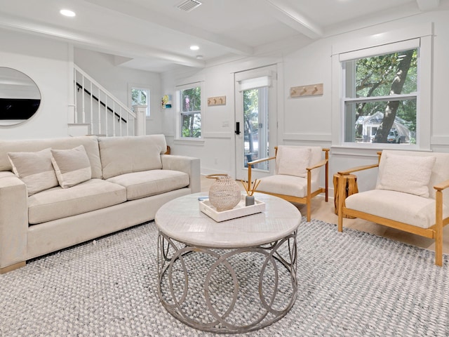 living room featuring beam ceiling and a wealth of natural light