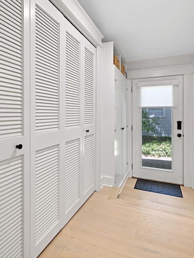 doorway to outside with light wood-type flooring