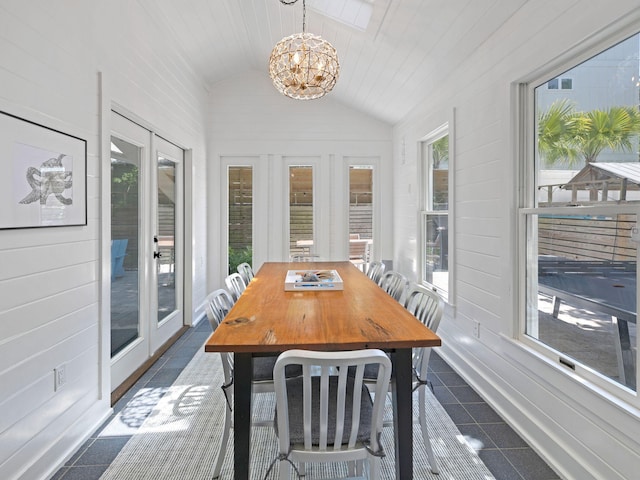 sunroom featuring a notable chandelier, a healthy amount of sunlight, lofted ceiling, and french doors