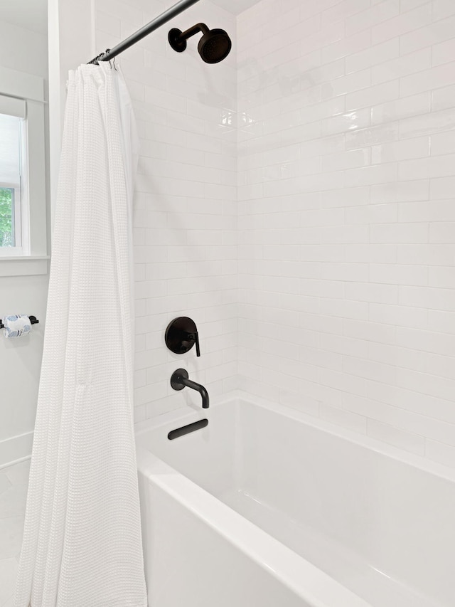 bathroom with shower / bathtub combination with curtain