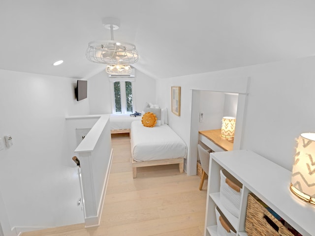 bedroom featuring light hardwood / wood-style floors and vaulted ceiling