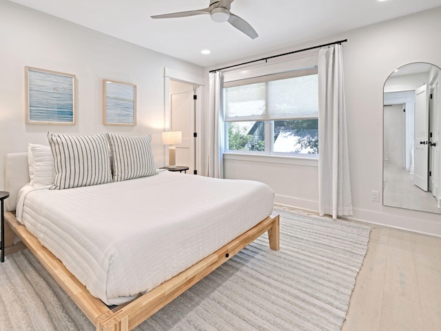 bedroom with light hardwood / wood-style floors and ceiling fan