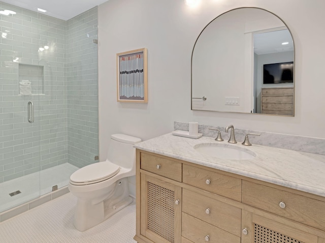 bathroom with tile patterned flooring, vanity, toilet, and a shower with door