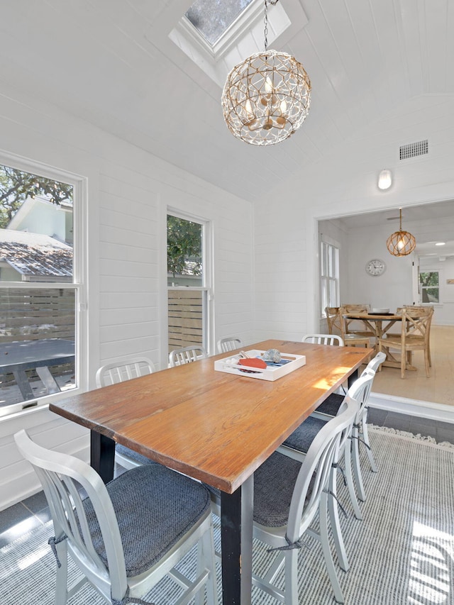 dining area with vaulted ceiling, a notable chandelier, and wood ceiling