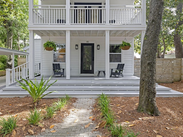 property entrance with a porch and a balcony