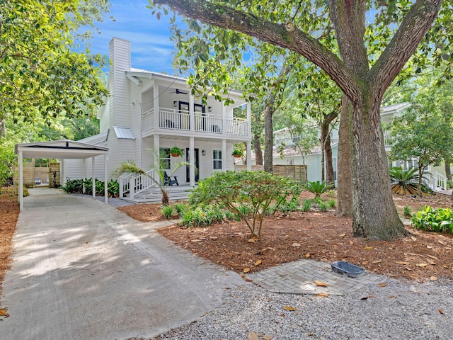 view of front of house with a porch, a carport, and ceiling fan