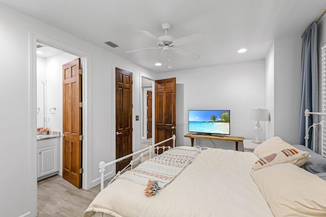 bedroom with ceiling fan, ensuite bathroom, and light hardwood / wood-style flooring