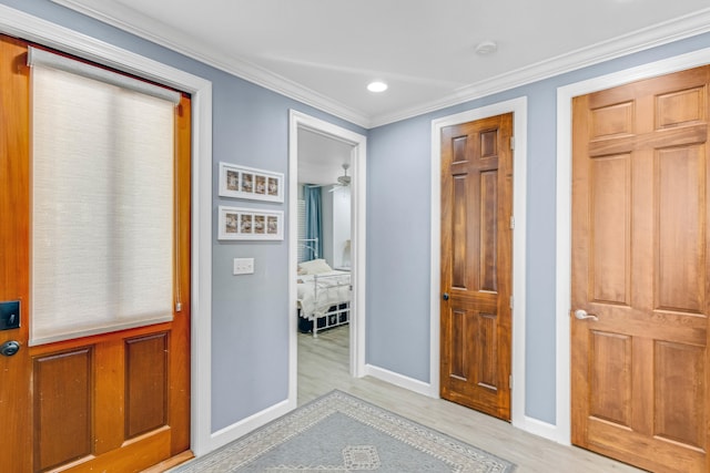 hallway with crown molding and light wood-type flooring