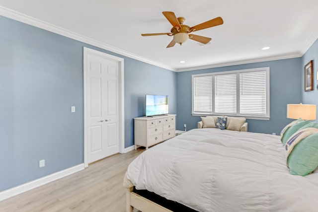 bedroom featuring ceiling fan, a closet, ornamental molding, and light hardwood / wood-style flooring