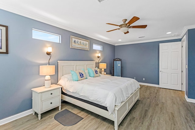 bedroom featuring ceiling fan, light hardwood / wood-style floors, and ornamental molding