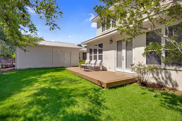 back of property with an outdoor living space, a deck, a yard, and french doors