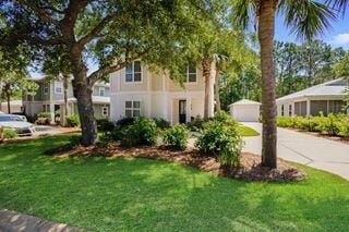 view of front of home featuring a garage, an outbuilding, and a front yard