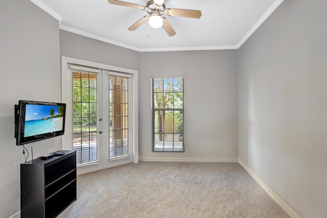 spare room featuring ceiling fan, plenty of natural light, and light colored carpet