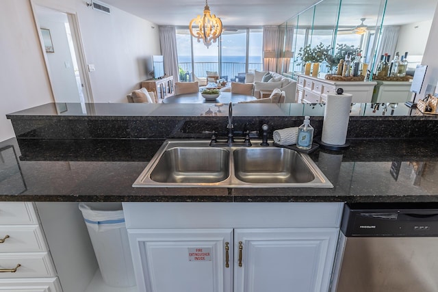 kitchen featuring dishwasher, white cabinets, a chandelier, and sink