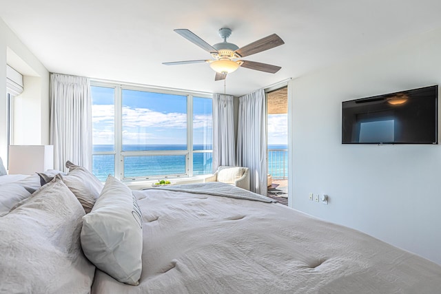 bedroom featuring ceiling fan and expansive windows