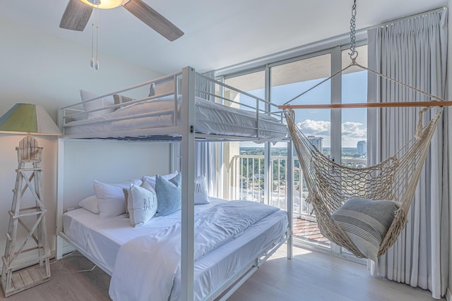 bedroom with hardwood / wood-style floors, access to outside, and ceiling fan