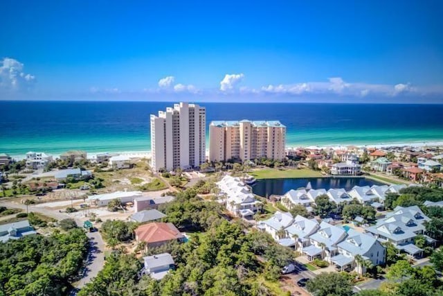 drone / aerial view featuring a beach view and a water view