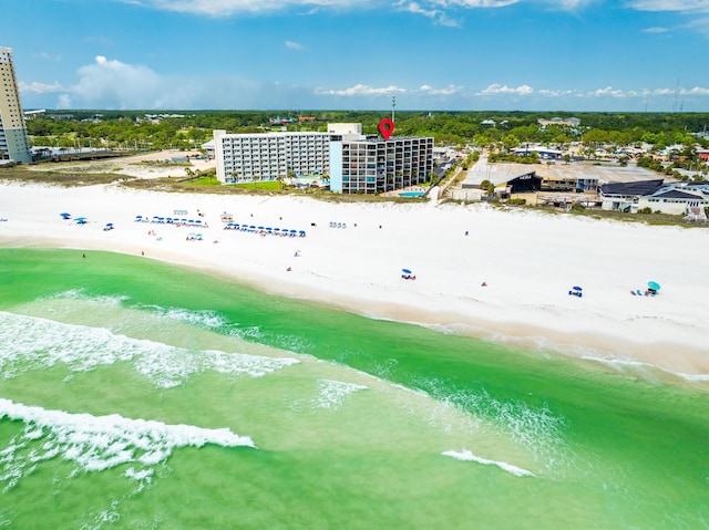 birds eye view of property featuring a water view and a beach view