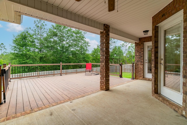 wooden terrace featuring a patio area and ceiling fan