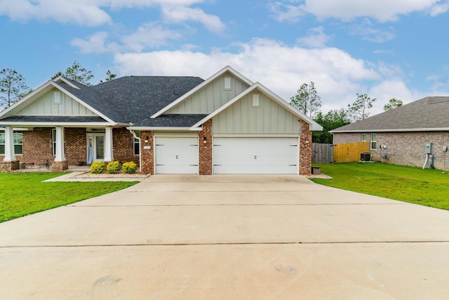 craftsman house featuring a front yard and a garage