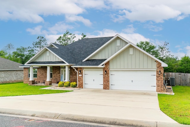 craftsman-style home featuring a front lawn, central AC unit, and a garage