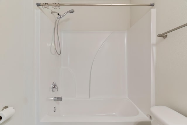 bathroom featuring toilet and washtub / shower combination