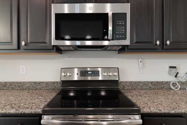 kitchen with stainless steel appliances and light stone counters