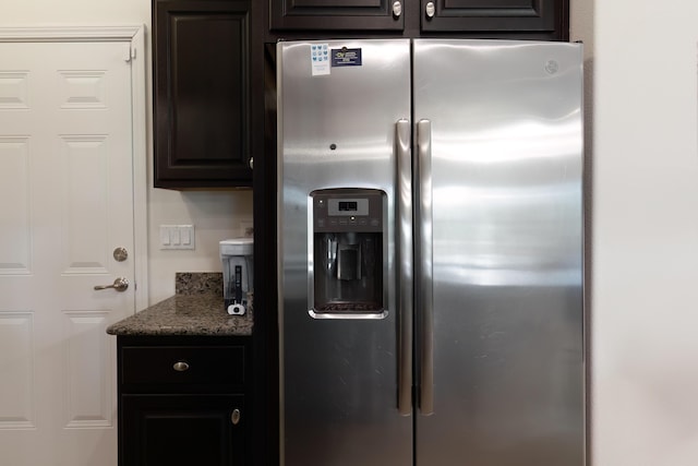 kitchen with light stone counters, stainless steel fridge with ice dispenser, and dark brown cabinetry