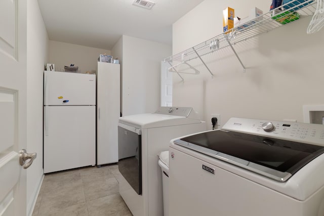 clothes washing area featuring washer and dryer