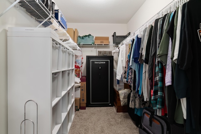 walk in closet featuring light carpet