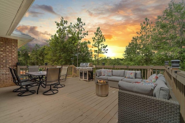 deck at dusk featuring an outdoor living space and area for grilling