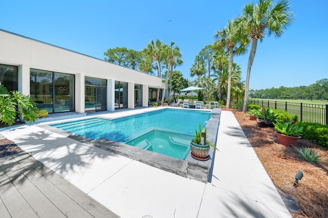 view of swimming pool with an in ground hot tub