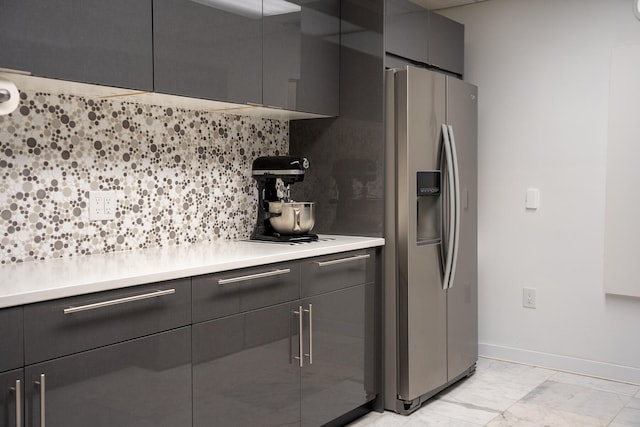 kitchen featuring backsplash, stainless steel fridge, and black cooktop