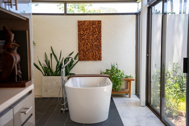 bathroom with a bath and plenty of natural light