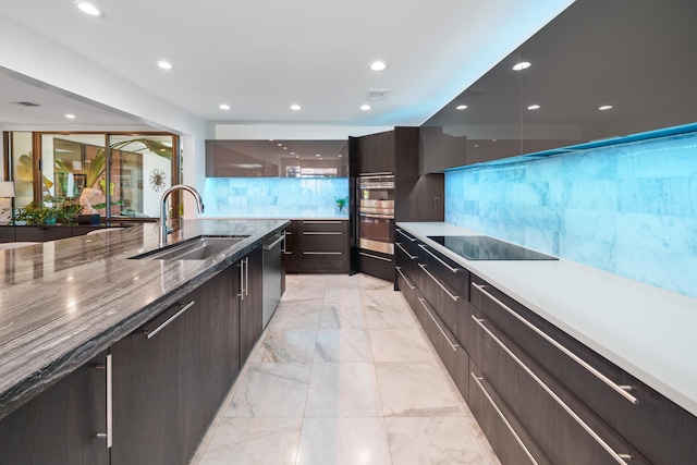 kitchen featuring decorative backsplash, dark stone countertops, sink, and appliances with stainless steel finishes