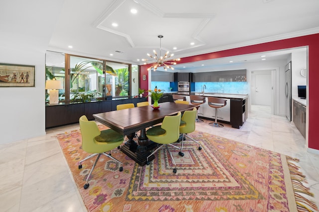 dining area with ornamental molding, sink, and an inviting chandelier