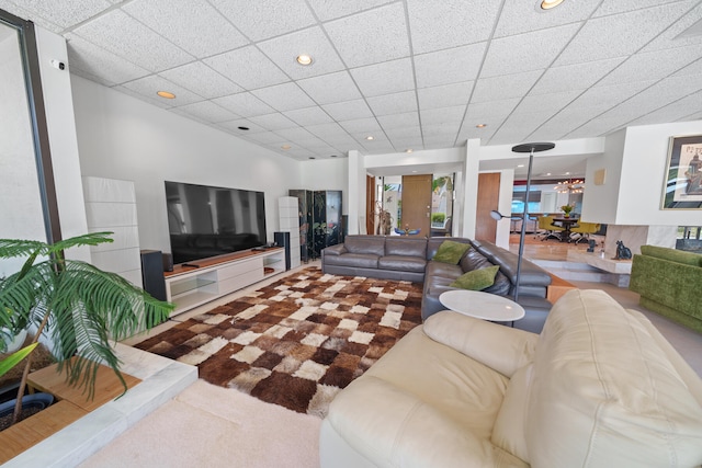 living room featuring a drop ceiling