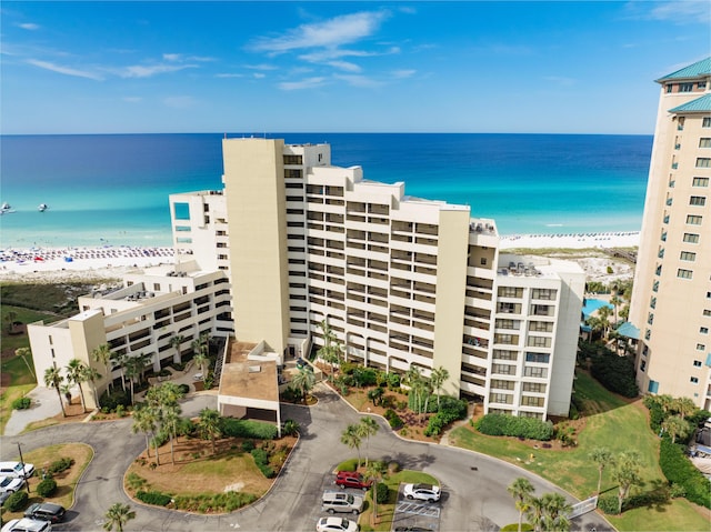 view of property featuring a water view and a beach view