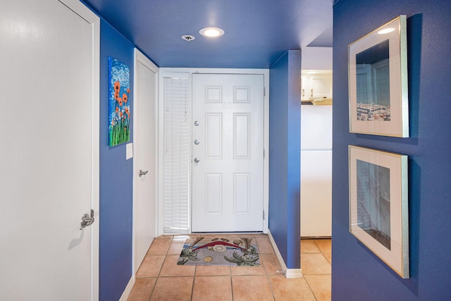 doorway to outside with light tile patterned floors