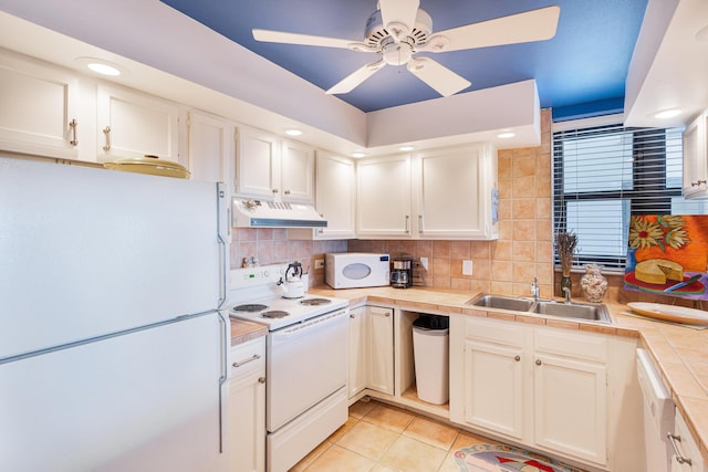 kitchen featuring white appliances, ceiling fan, light tile patterned floors, tile countertops, and white cabinetry