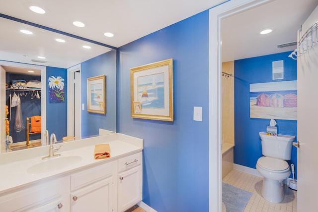 full bathroom featuring tile patterned floors, vanity, shower / bath combination with curtain, and toilet