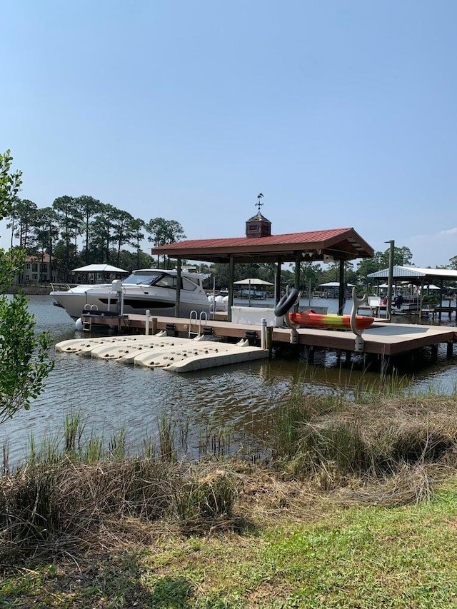 dock area with a water view and boat lift