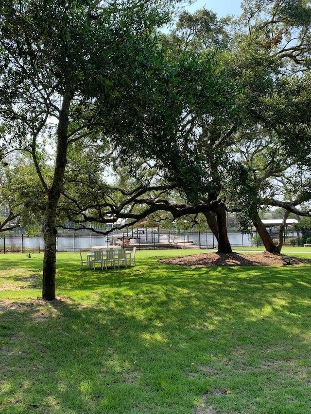 view of yard featuring a water view and fence