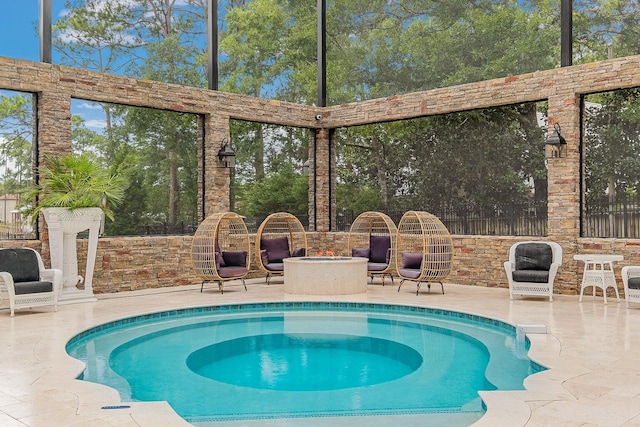 view of pool featuring a patio area, a fire pit, and an in ground hot tub