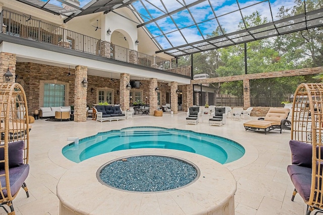 pool with glass enclosure, a patio area, an outdoor living space, and a ceiling fan