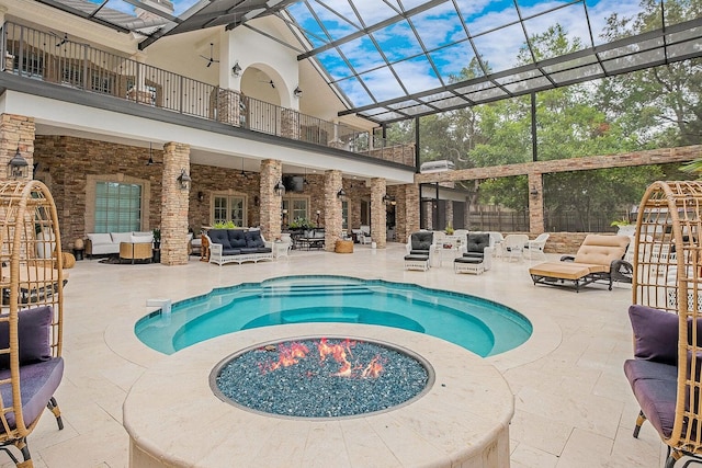 pool featuring a patio area, ceiling fan, glass enclosure, and outdoor lounge area