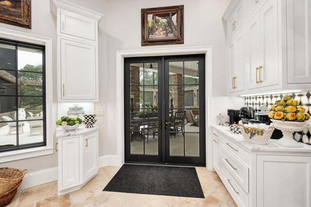 interior space featuring french doors and baseboards